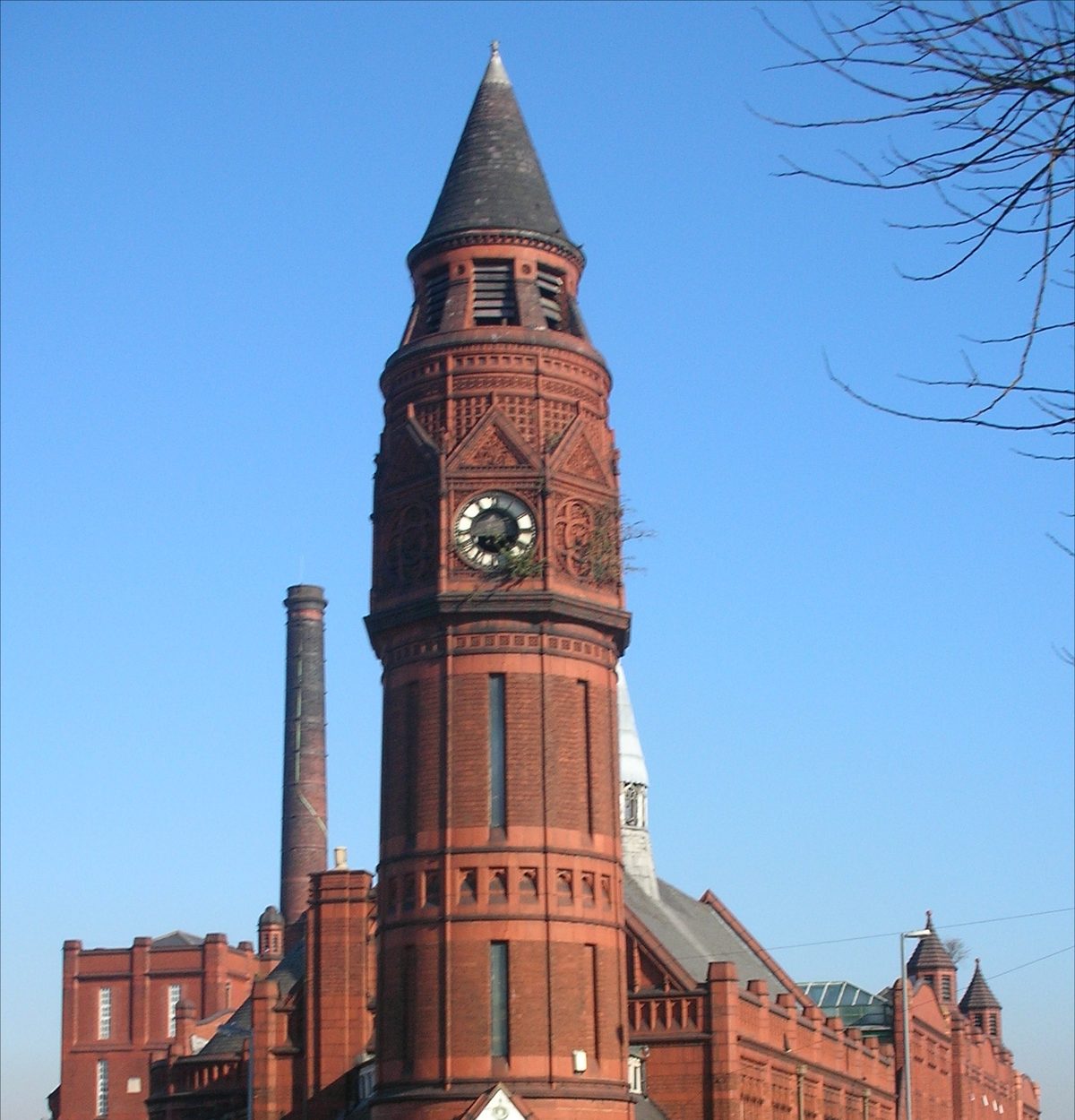 Green Lane Masjid in Small Heath, Birmingham — a Grade II listed red-brick building with a distinctive corner clock tower.